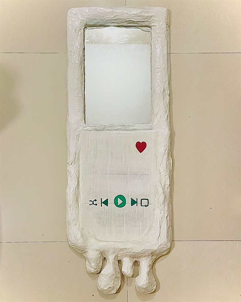 Handmade white mirror shaped like an old music player, with play controls and a red heart